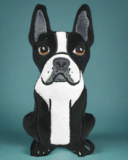 Stuffed toy of a black and white dog on a transparent background. Made by Not Your Nana in Dunedin, New Zealand