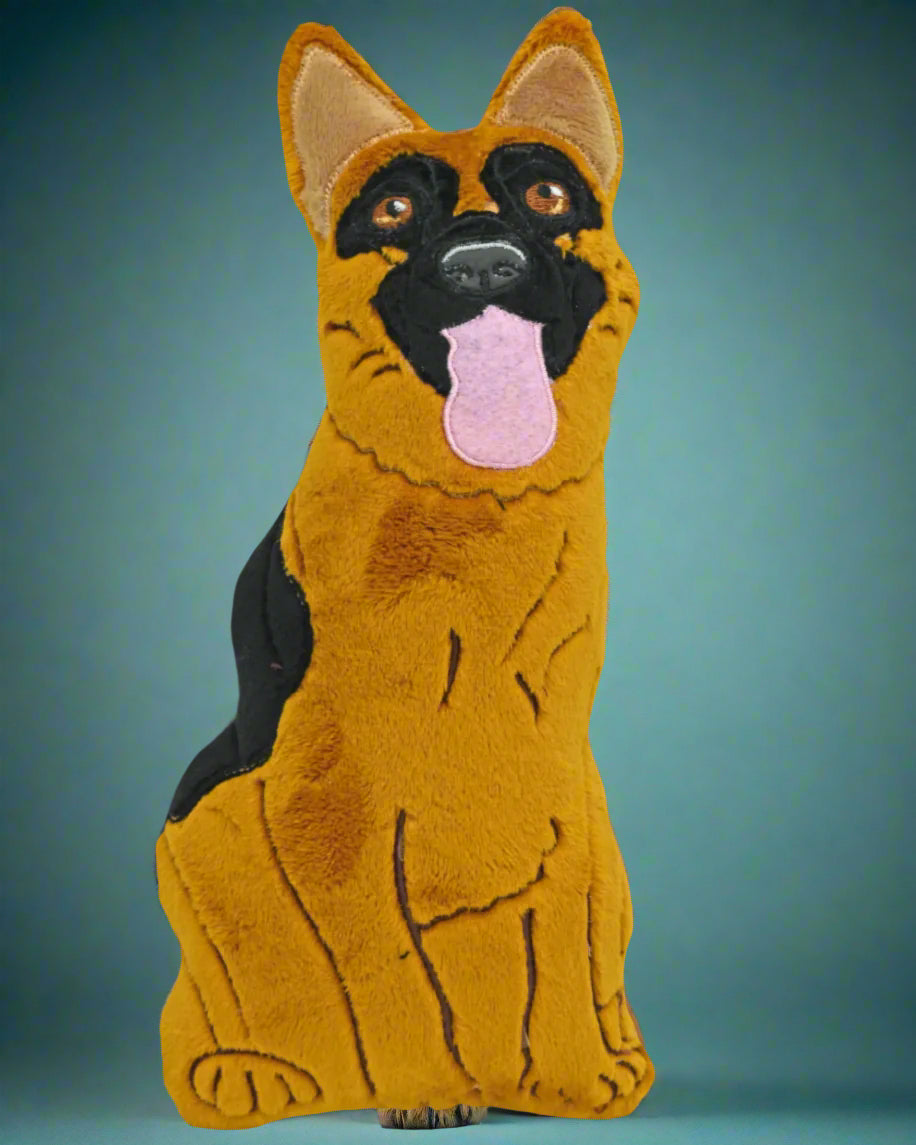 This is a soft toy German Shepherd with soulful eyes. He is sticking his tongue out. Made by Not Your Nana in Dunedin. New Zealand
