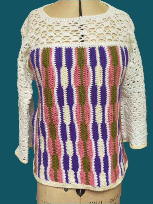 This is a crocheted sweater. The yoke and sleeves are lace crochet, and the body has multi-coloured vertical stripes. It was made by Not Your Nana in Dunedin, New Zealand.