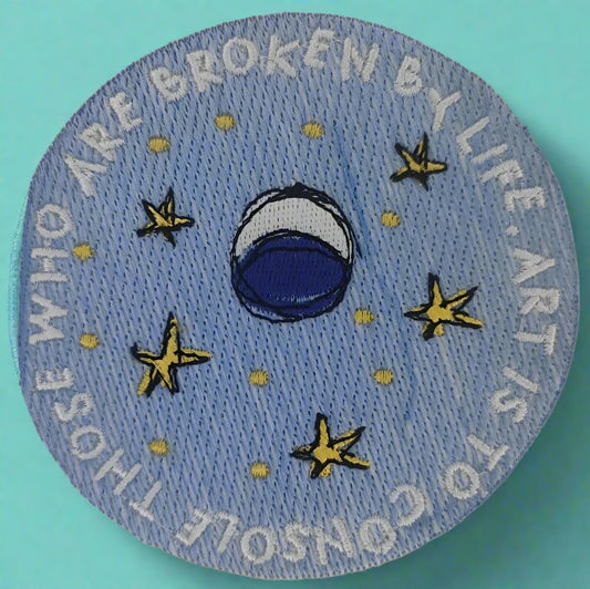 Circular patch with blue circle and stars with the words "Art is to console those who are broken by life" Made by Not Your Nana in Dunedin, New Zealand.