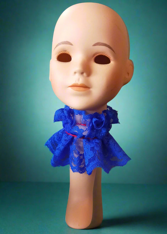 Porcelain doll head tealight wearing a blue lace dress. Made by Not Your Nana, Dunedin, New Zealand