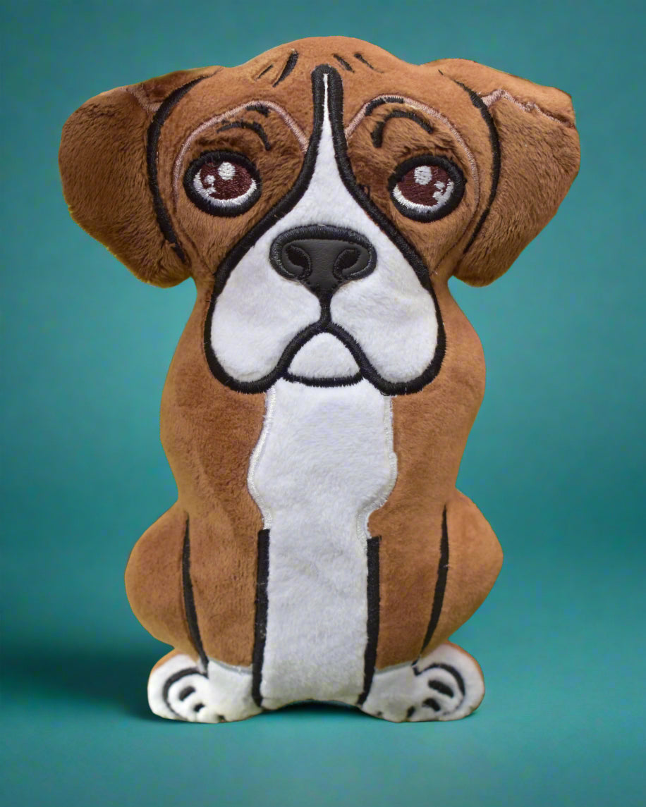 This is  Boxer dog soft toy. It is tan and white with sad eyes. Made by Not Your Nana in Dunedin, New Zealand