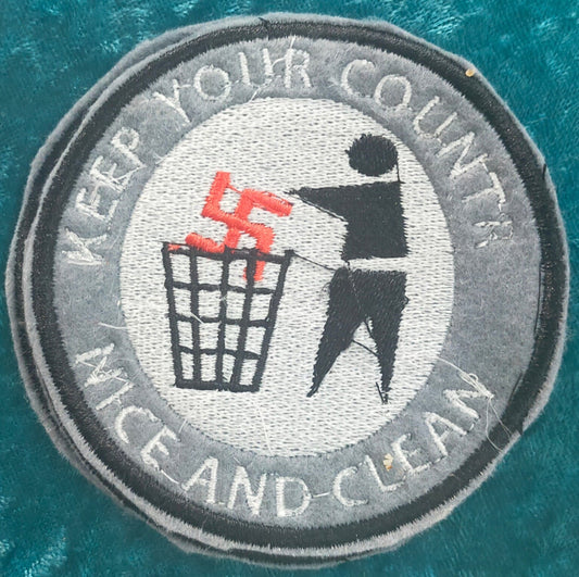 Patch of a person throwing a swastika into a rubbish bin with the words "keep your country nice and clean." Made by Not Your Nana, Dunedin, New Zealand
