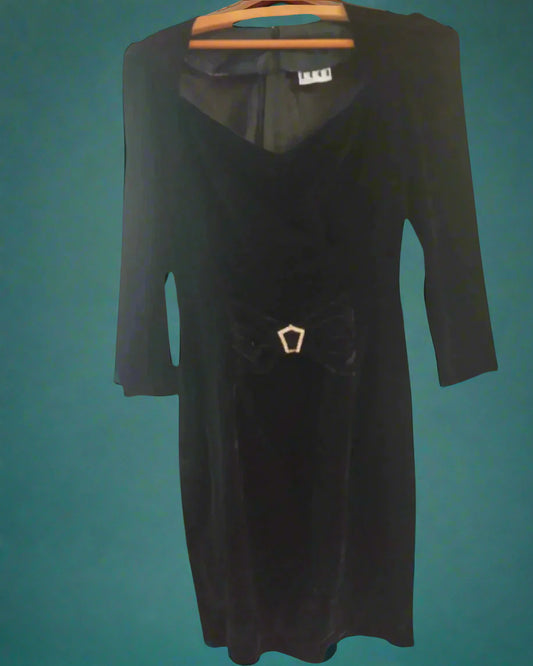 This is a figure hugging black velvet dress with a small diamante buckle. Made by Not your Nana in dunedin, New Zealand