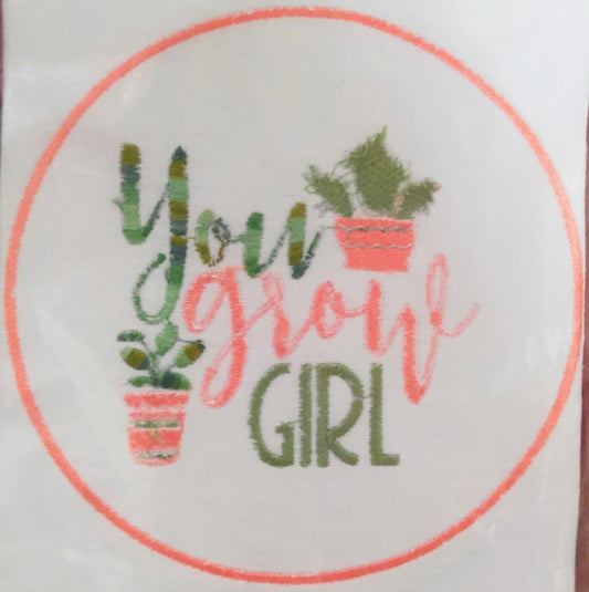 Embroidery with 'You Grow Girl' text and potted plants on a white background.