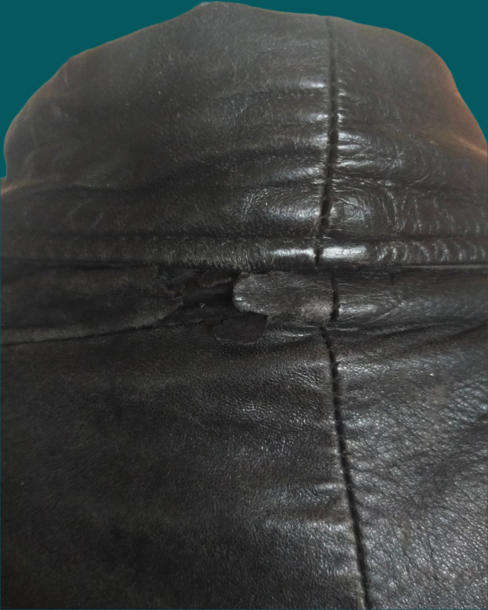 This is a black leather wrap coat with a collar and pockets