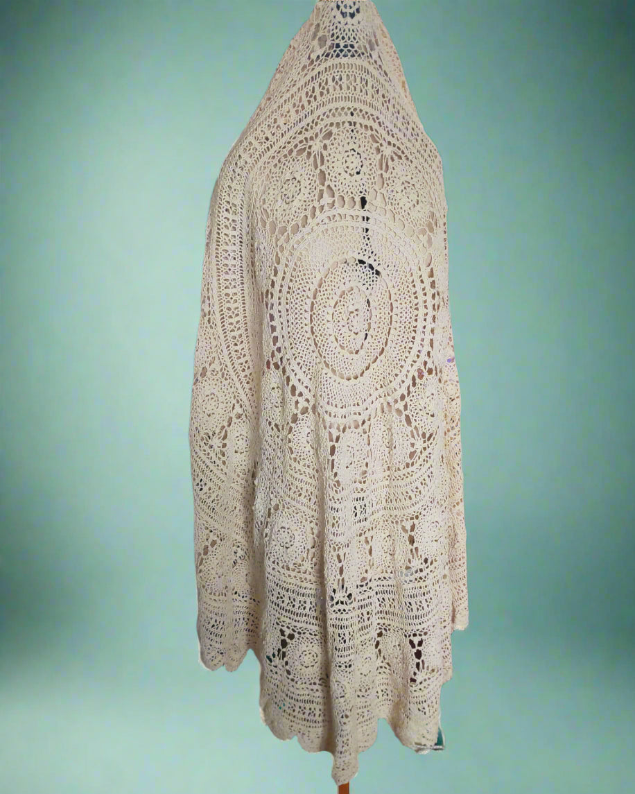 This is a large crocheted beige circular tablecloth. It is 2m across. Found by Not Your Nana in Dunedin, New Zealand.
