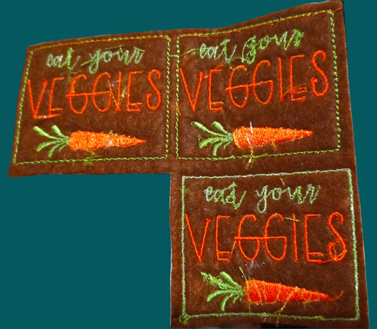 This is  small iron on patch with the image of a carrot with the words "Eat your carrots" Made by Not Your Nana, Dunedin, New Zealand