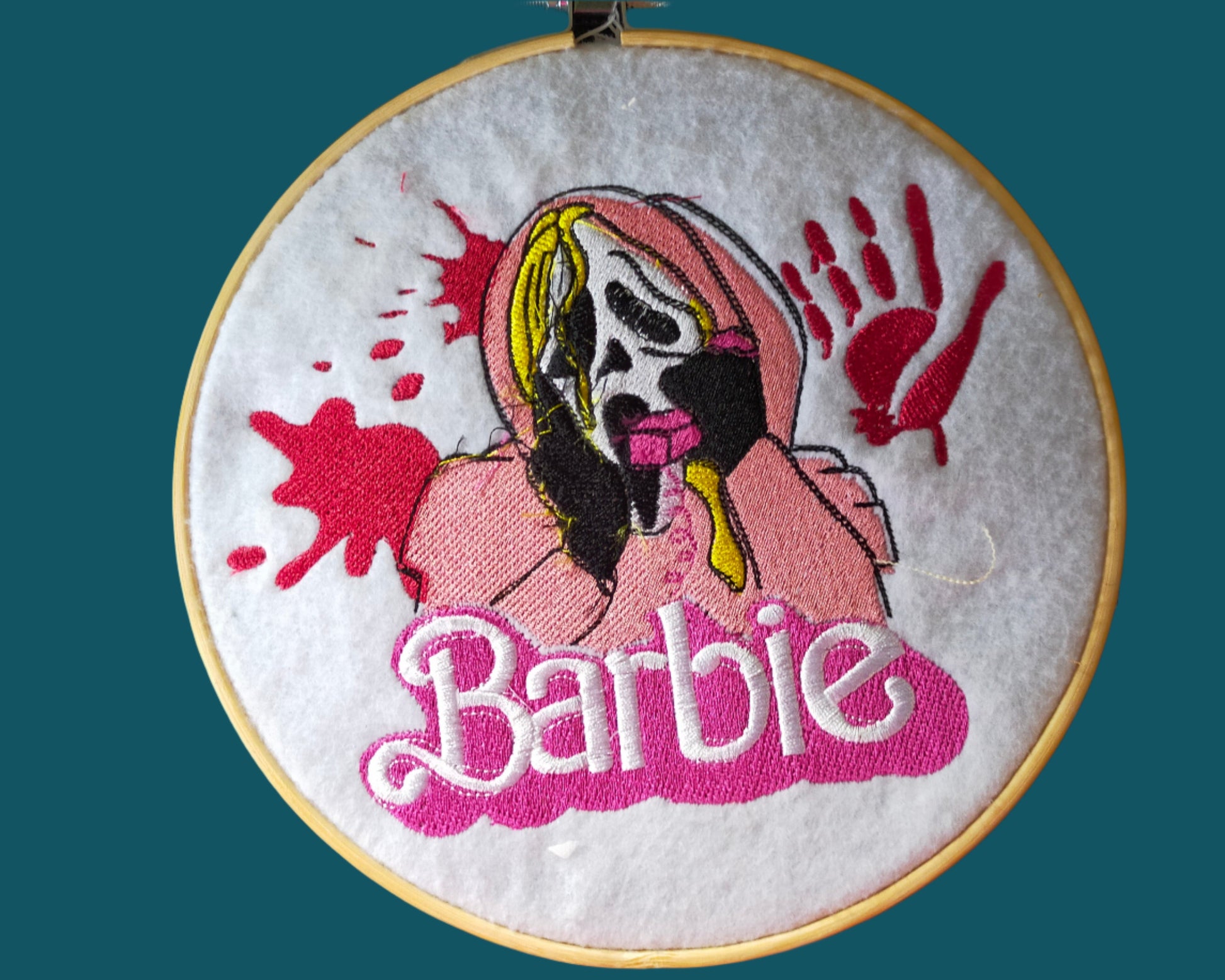 This is an embroidery of the horro character Ghostface with a pink phone and the word Barbie. Made by Not Your Nana in Dunedin. New Zealand.