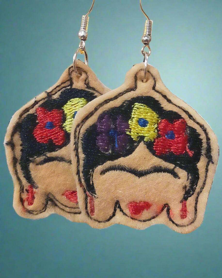 This is a set of embroidered felt Frida Kahlo earrings