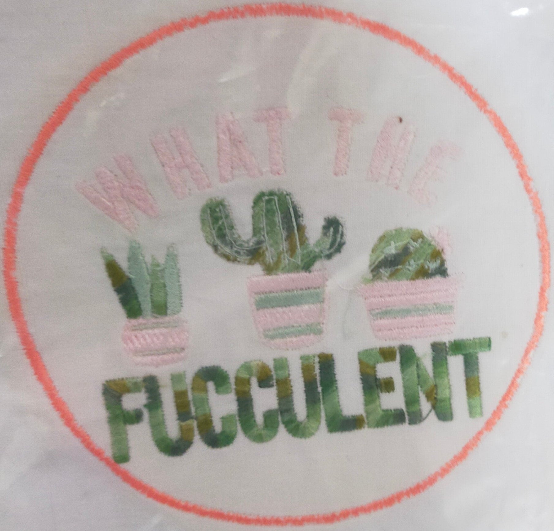 Embroidery design with cacti and text 'WHAT THE Fucculent' on a white background