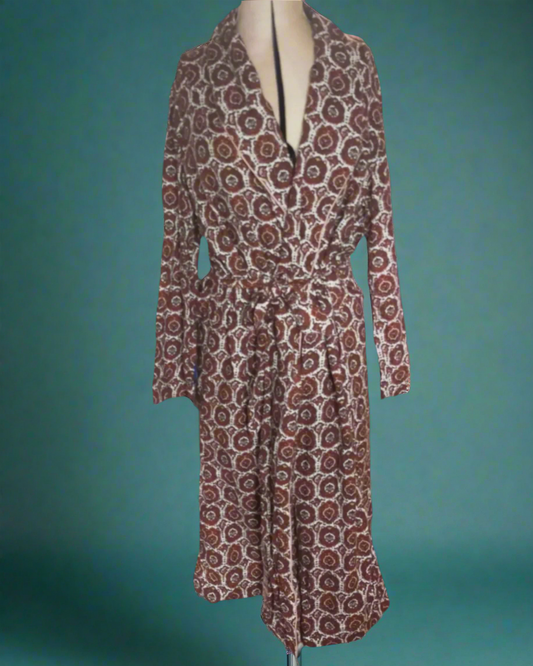 This is a vintage cotton dressing gown. It is cream with a brown paisley pattern. Sold by not Your nana in Dunedin, New Zealand