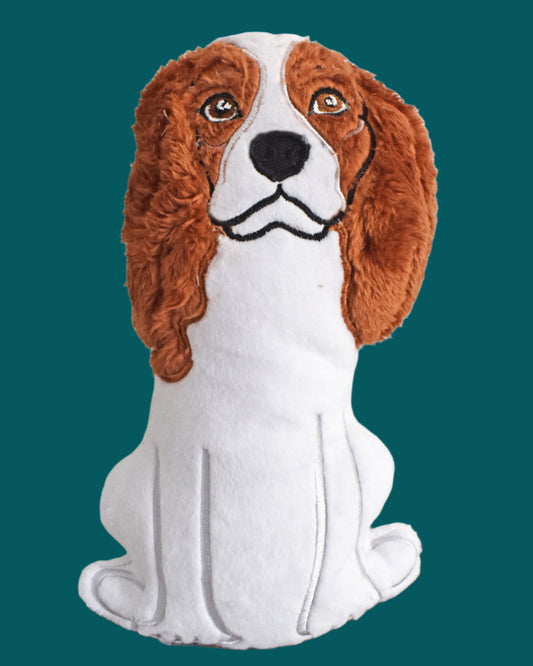 This is a Spaniel soft toy with soulful eyes. It is black, white or brown. Made by Not your Nana in Dunedin, New Zealand.