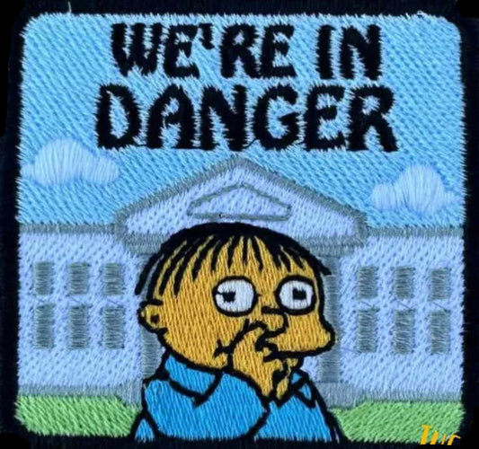 Embroidered patch with Ralphie from The Simpsons and text 'We're in danger' with the White House in the background.Made by Not Your Nana in Dunedin,  NZ