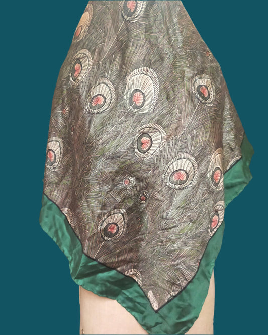 This is a beautiful, luxurious Liberty silk scarf in green and grey. The fabric design is that of peacock feathers in a green and gry colourway