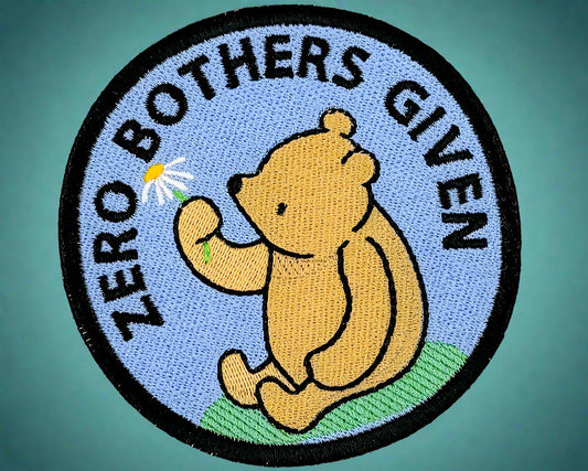 Circular patch with a bear holding a flower and 'Zero Bothers Given'  text. Made by Not Your Nana in Duedin, New Zealand