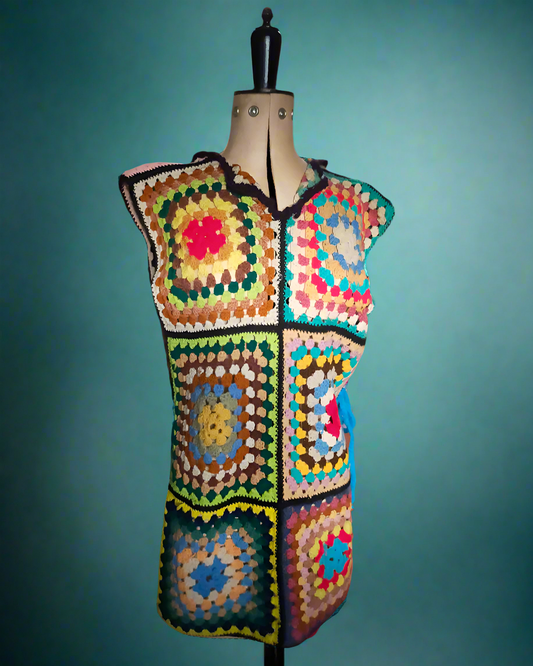 This is a multi coloured peggy square tabard which ties at the side. Made by Not Your Nana in DUnedin, New Zealand