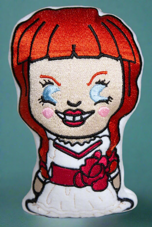 Stuffie  of a cartoon Bride of Chucky with red hair and a white dress. Made by Not Your Nana, Dunedin, New Zealand