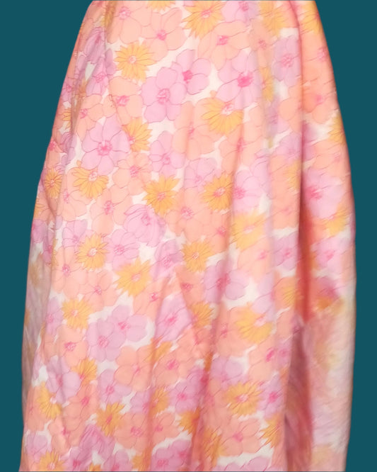 This single size duvet/ comforter has a large floral pattern in pastel shades of pink yellow and mauve.The outer fabric is eith cotton or polycottn. It has a polyfil inner, is easy to launder. Attached are side valances and a pillow protector