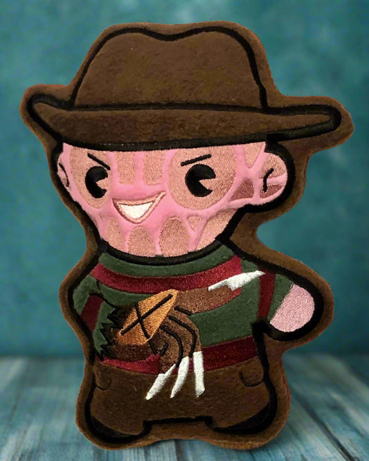 Cartoon Freddy Krueger character with a brown hat and green sweater on a red and white background made by Not Your Nana in Dunedin, ew Zealand
