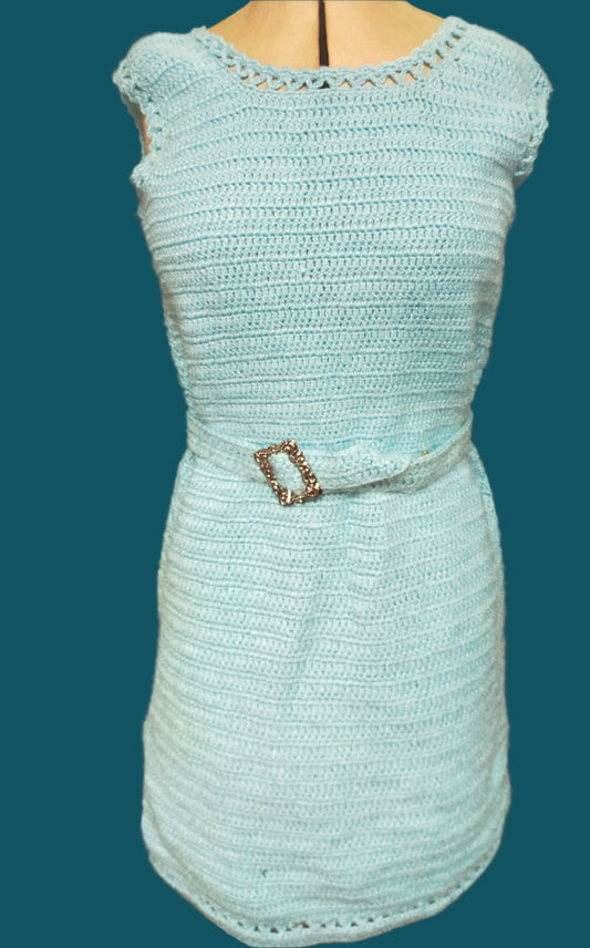 This is a pale blue crochet dress with a tiny bit of sparkle and crochet lace edging. It has a matching belt. In DUnedin, New Zealand