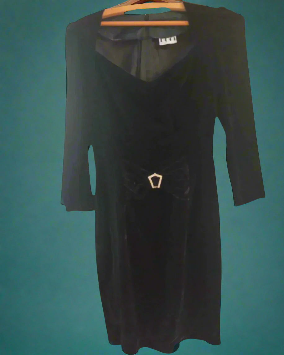 This is a figure hugging black velvet dress with a small diamante buckle. Made by Not your Nana in dunedin, New Zealand
