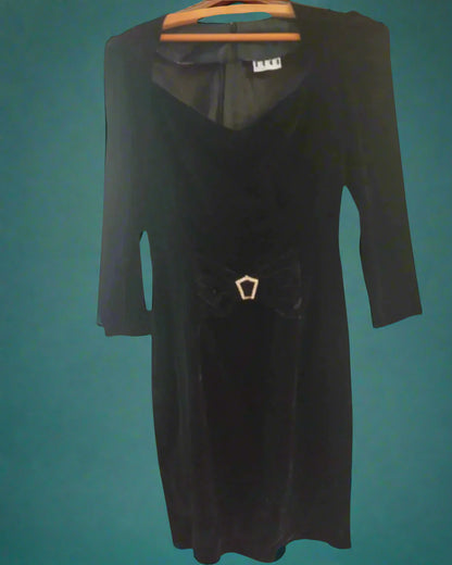 This is a figure hugging black velvet dress with a small diamante buckle. Made by Not your Nana in dunedin, New Zealand