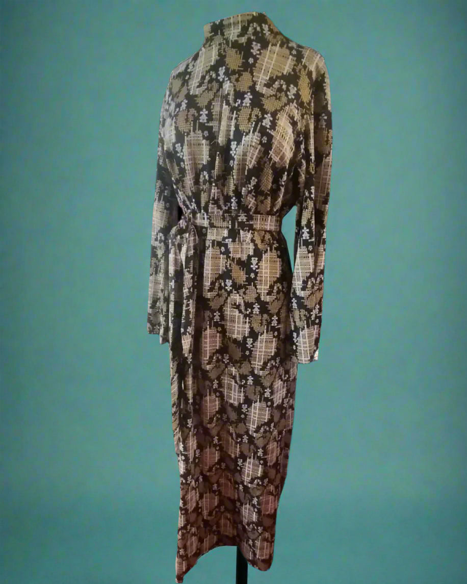This is a long black, white and gold sparkly dress. it has a sash and a high neck. Made by your Not Your Nana in Dunedin, New Zealand