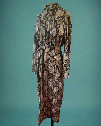 This is a long black, white and gold sparkly dress. it has a sash and a high neck. Made by your Not Your Nana in Dunedin, New Zealand