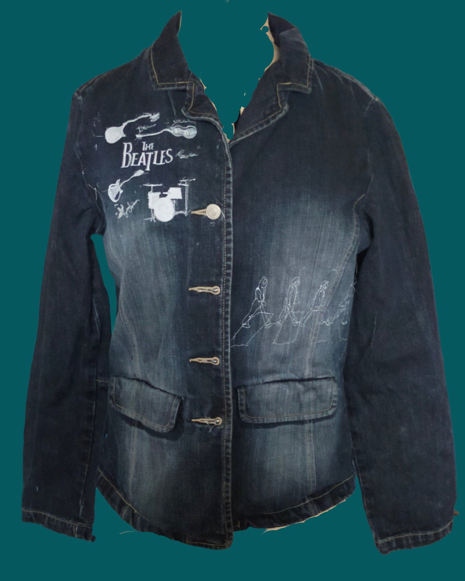 This is a small dark blue denim jacket embellished with images of the Beatles. Made by Not Your Nanain Dunedin, New Zealand