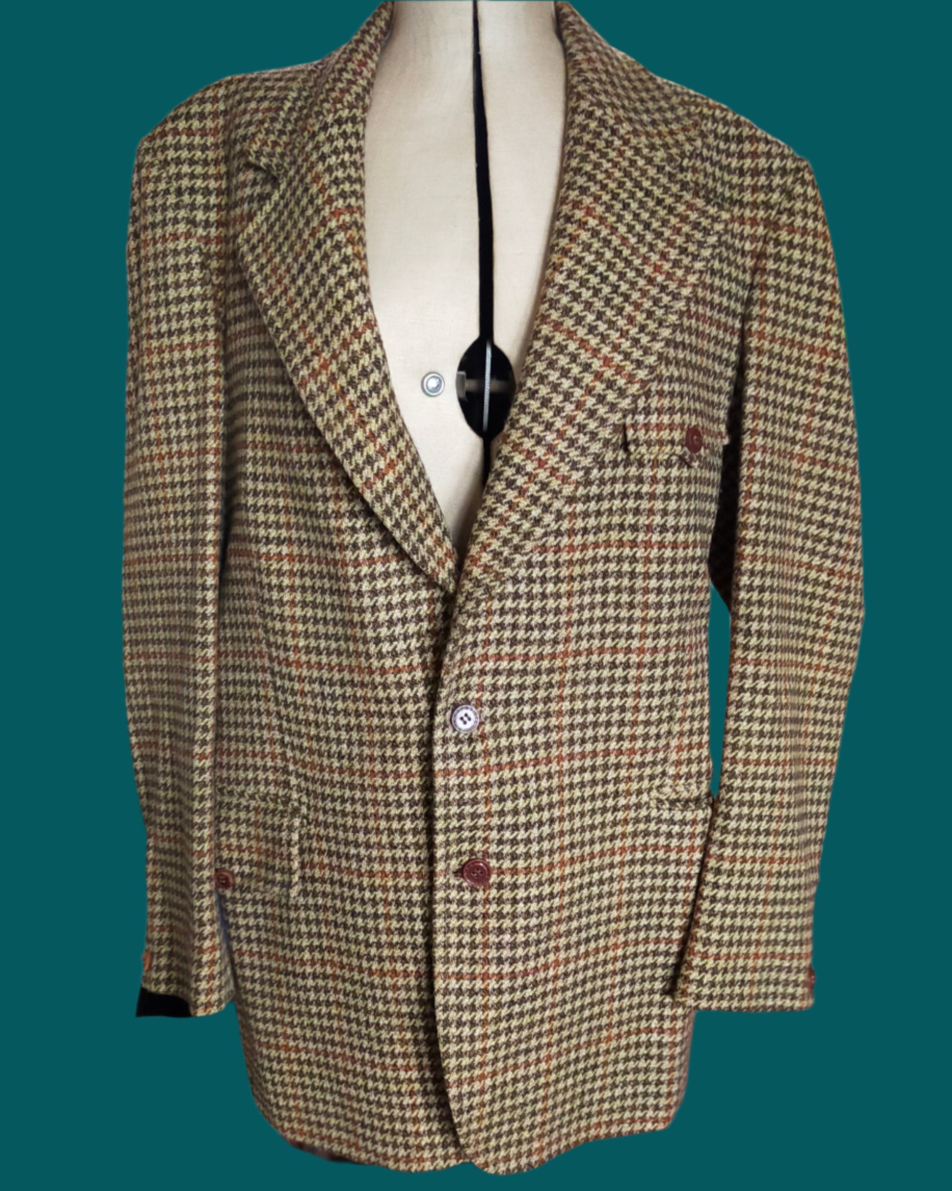 This is a pure wool  houndstooth sports jacket by Hardy Amies. The colourway is beige, bronze and brown. Found by Not Your Nana in Dunedin, New Zealand.