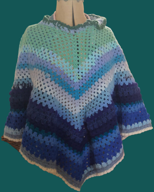 This is a poncho in shades of blue, Made by Not your Nana in Dunedin, New Zealand