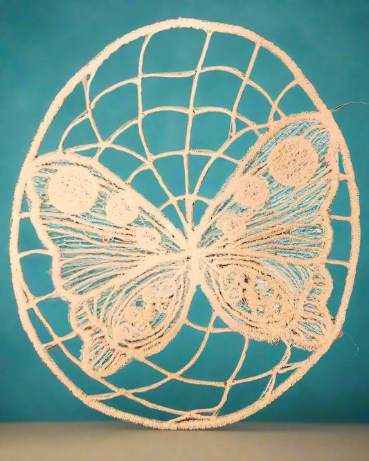 Embroidered lace design of a butterfly and web made by Not Your Nana in Dunedin, New Zealand
