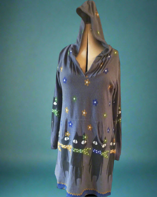 This grey dress has a hood and a floral pattern with large cats.