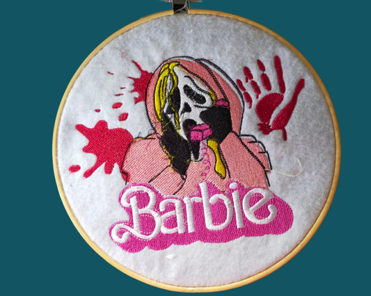 This is an embroidery of the horro character Ghostface with a pink phone and the word Barbie. Made by Not Your Nana in Dunedin. New Zealand.
