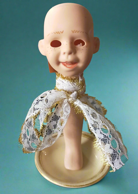 Porcelain doll head tealight with a lace garment. Made by Not Your Nana in Dunedin, New Zealand.