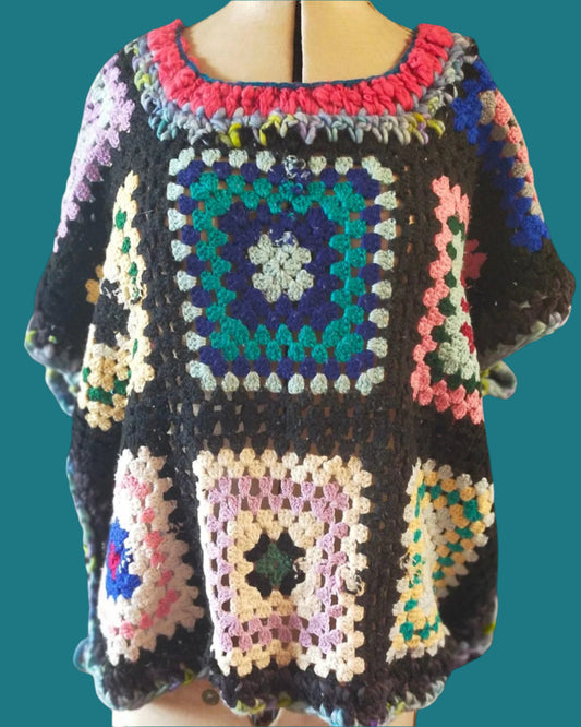 This is a multi coloured loosely fitted crochet top. 