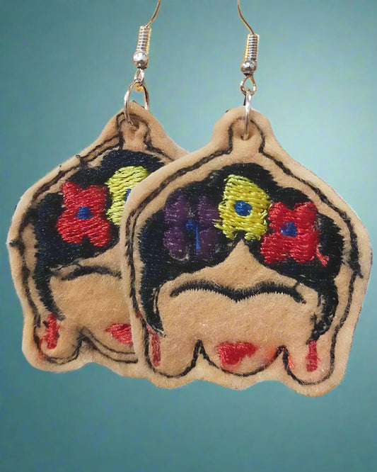 This is a set of embroidered felt Frida Kahlo earrings