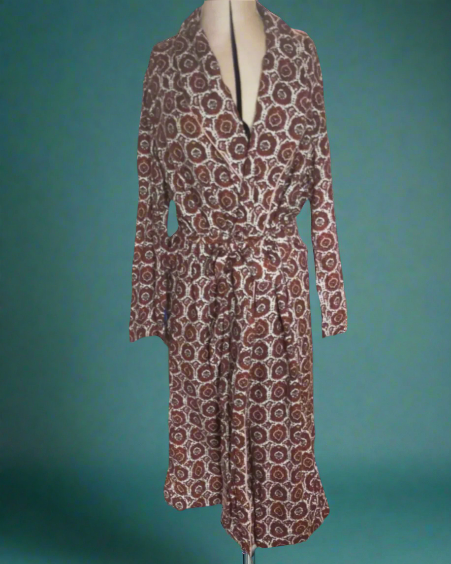 This is a vintage cotton dressing gown. It is cream with a brown paisley pattern. Sold by not Your nana in Dunedin, New Zealand