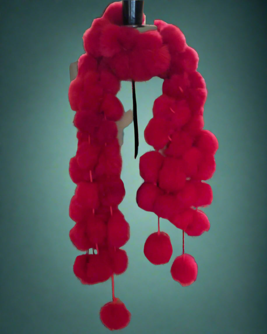 Mannequin with red pom-pom scarf 