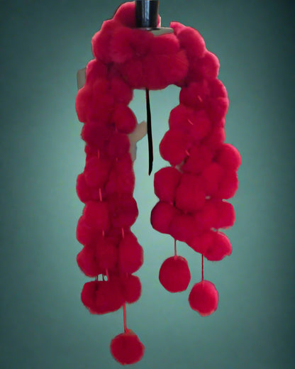 Mannequin with red pom-pom scarf 